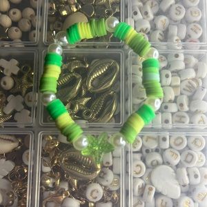 This is a green pearl and starfish clay bead bracelet